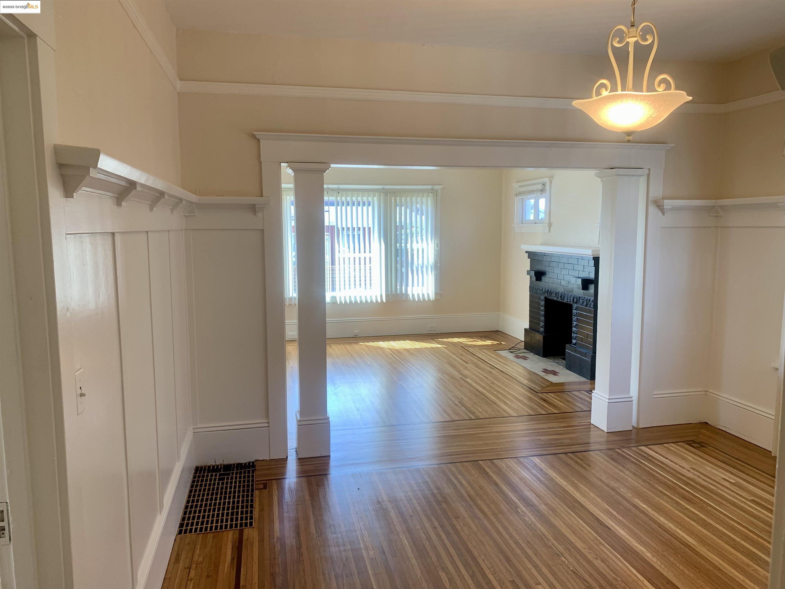 1028 61st Street Oakland, CA 94608 - Photo 7 of 28 a view of empty room with wooden floor and fan