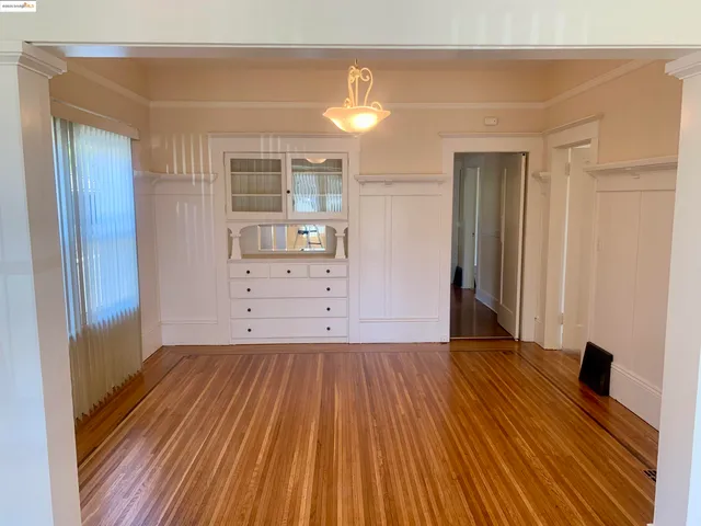 a view of a room with wooden floor and cabinet