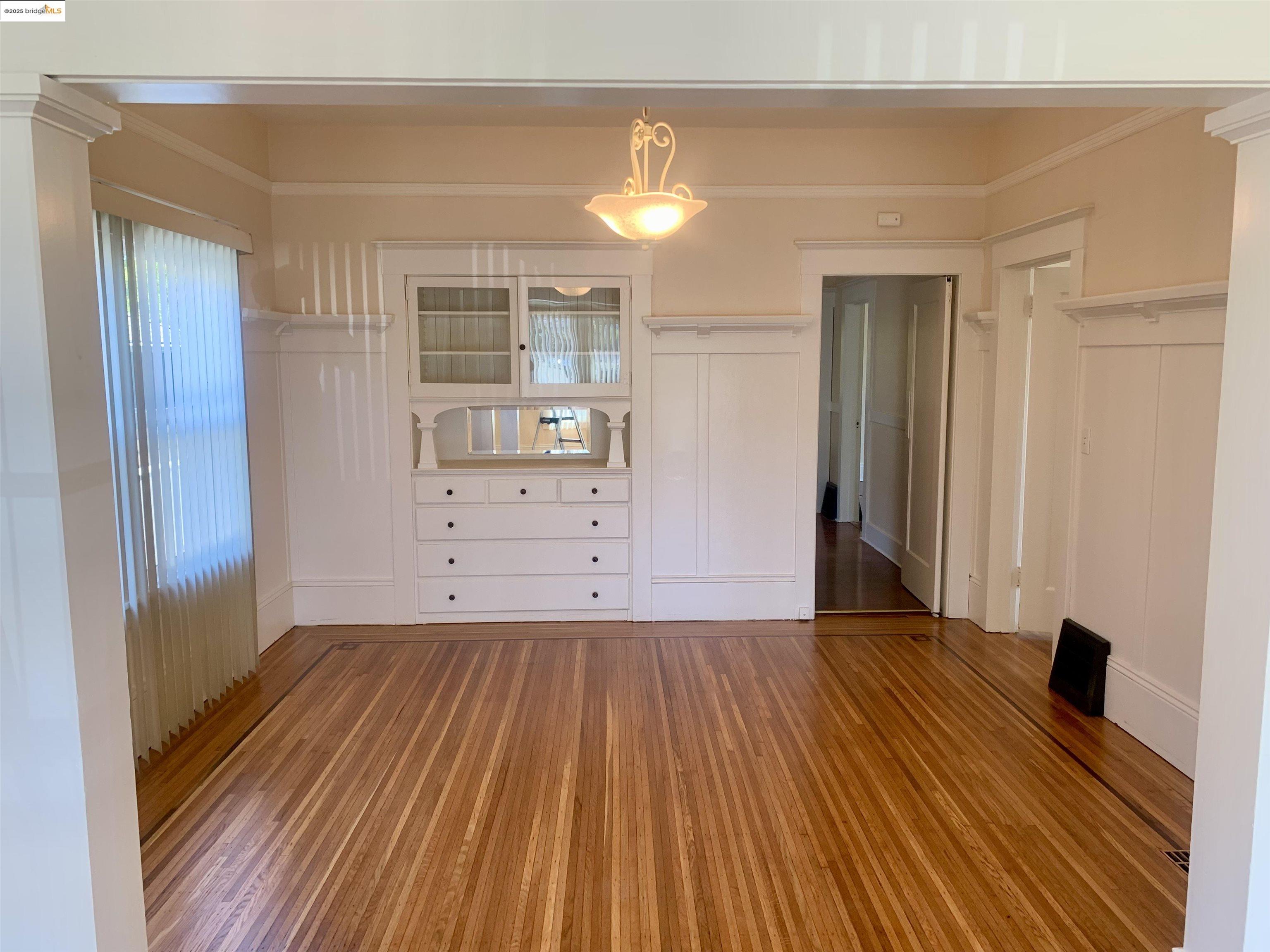 1028 61st Street Oakland, CA 94608 - Photo 9 of 28 a view of a room with wooden floor and cabinet