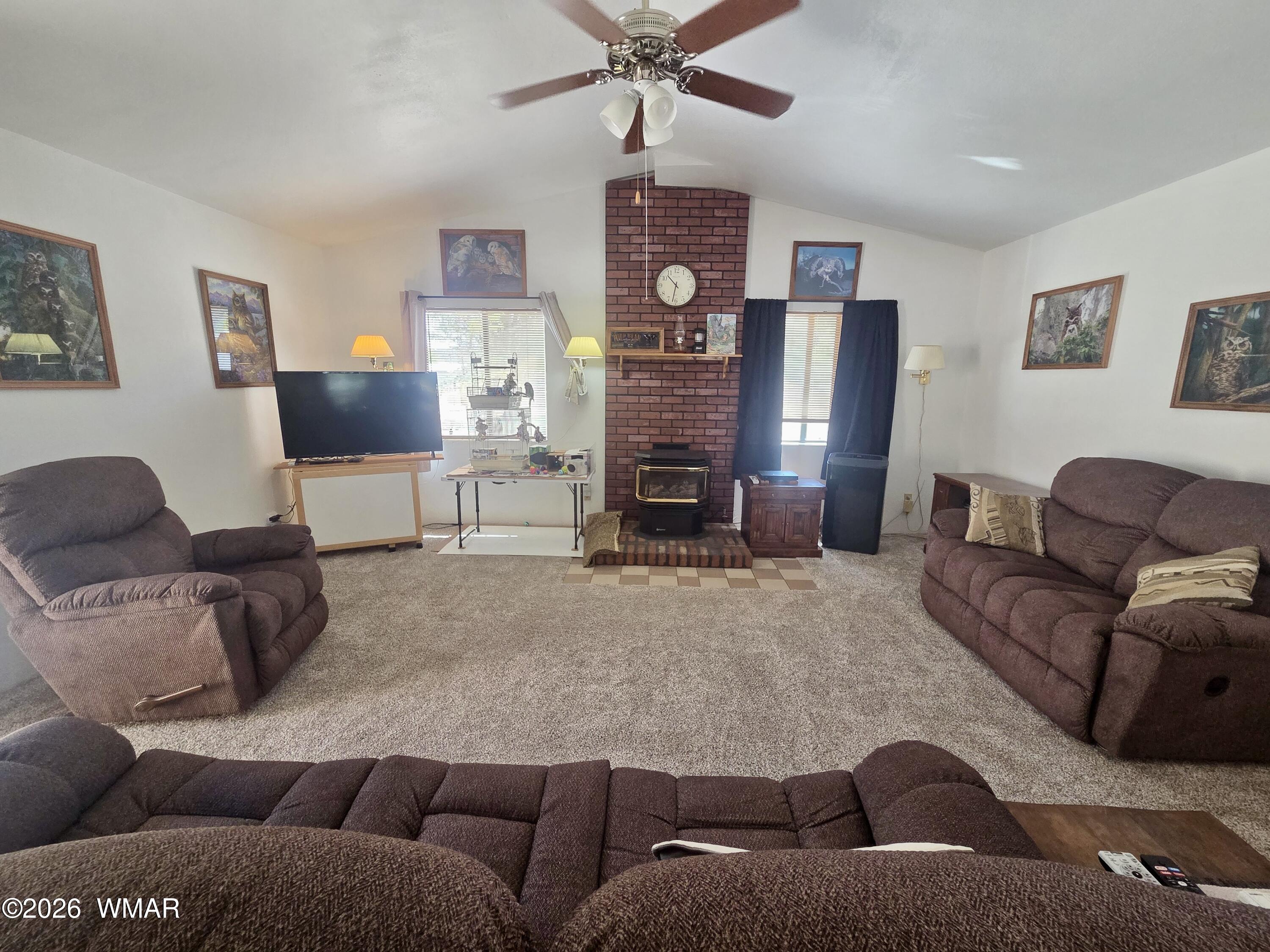 727 South Butler Street Eagar, AZ 85925 - Photo 10 of 32 a living room with furniture and a fireplace