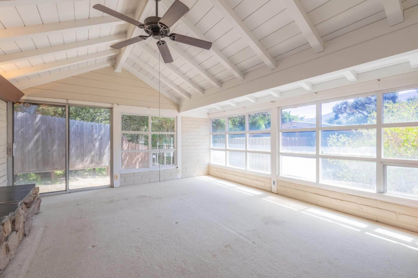 72 Los Laureles Grade Road Carmel Valley, CA 93924 - Photo 8 of 43 a view of an empty room with windows and a ceiling fan