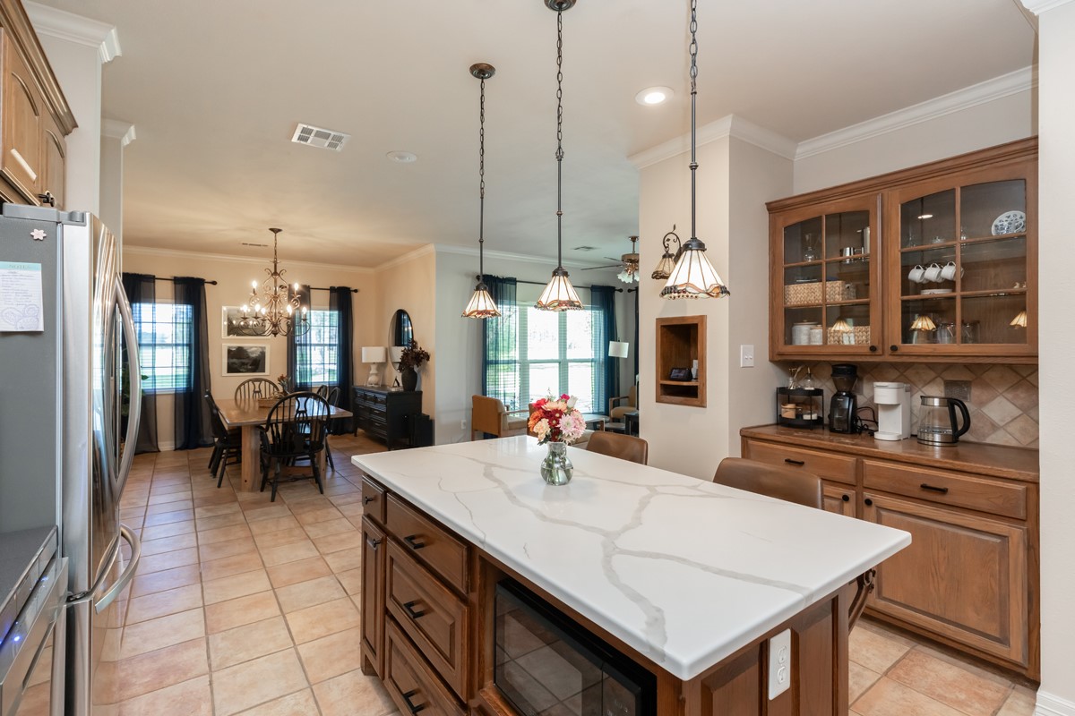 430 Bonura Road Sour Lake, TX 77659 - Photo 17 of 50 a kitchen with a stove a kitchen island a sink and cabinets