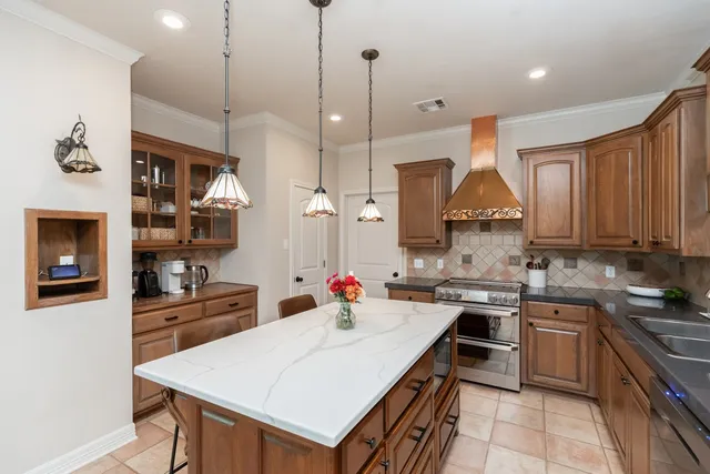 a kitchen with a sink a stove and chairs
