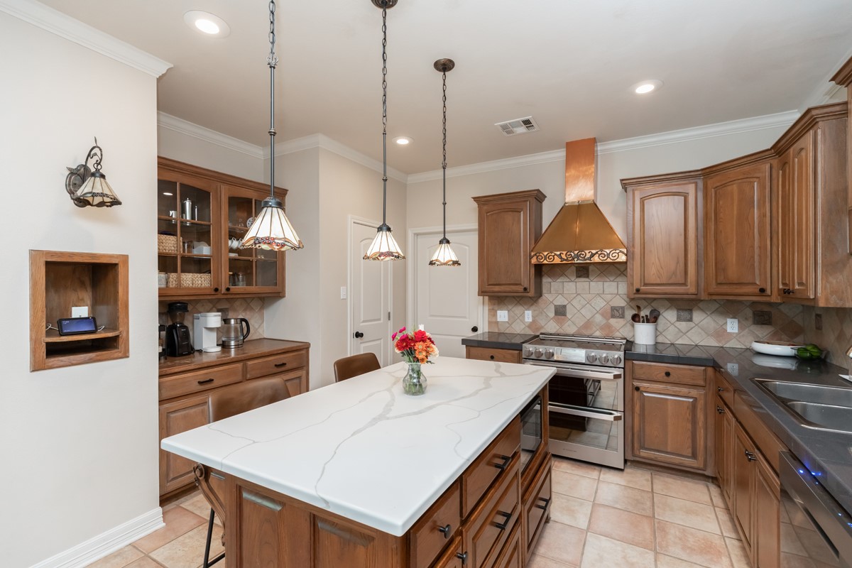 430 Bonura Road Sour Lake, TX 77659 - Photo 18 of 50 a kitchen with a sink a stove and chairs