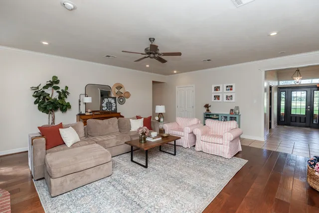 a living room with furniture or wooden floor and a chandelier