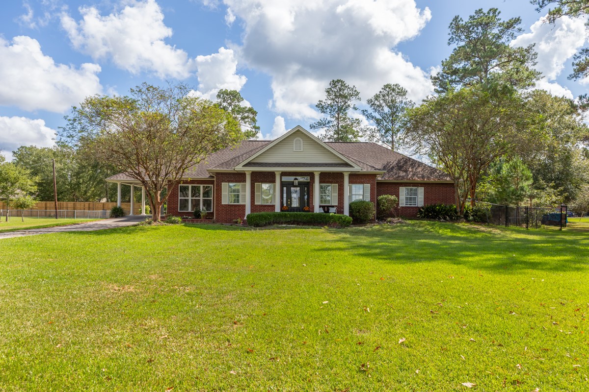 430 Bonura Road Sour Lake, TX 77659 - Photo 2 of 50 a front view of a house with a garden