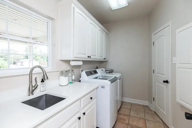 a kitchen with a sink cabinets and window