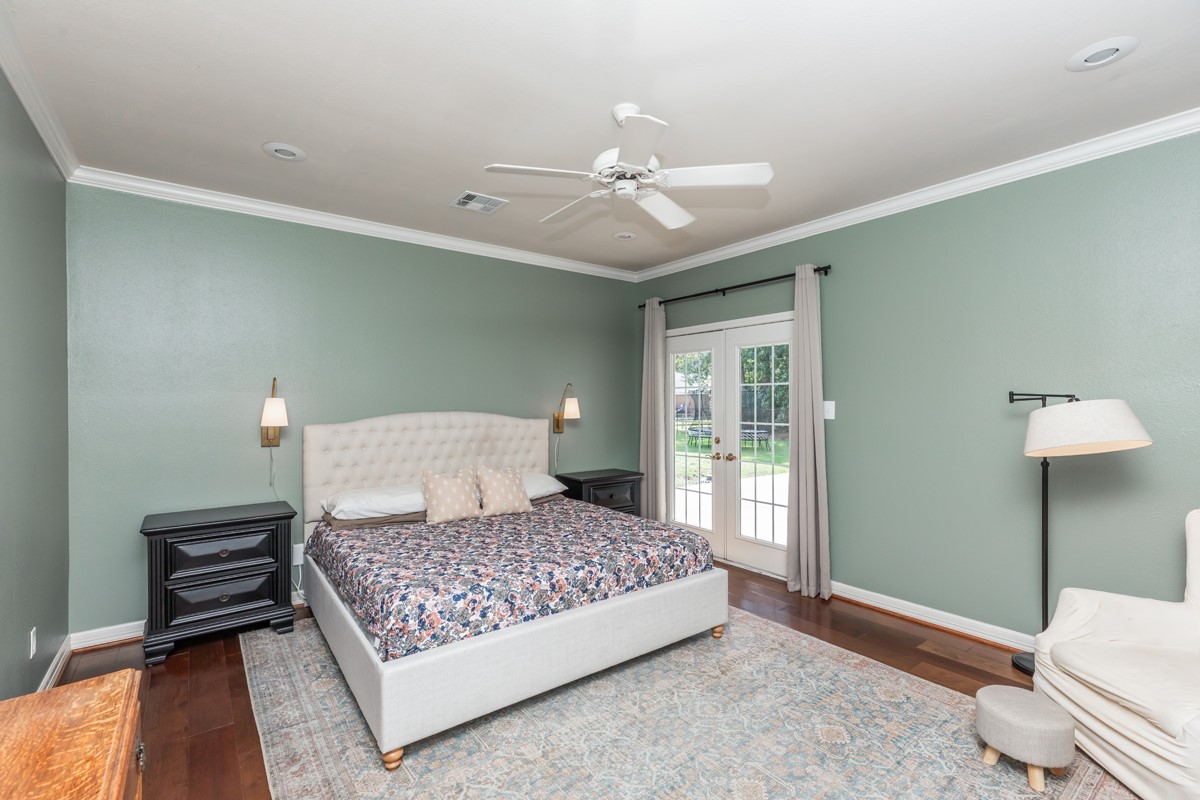 430 Bonura Road Sour Lake, TX 77659 - Photo 25 of 50 a bedroom with a large bed chandelier and a window