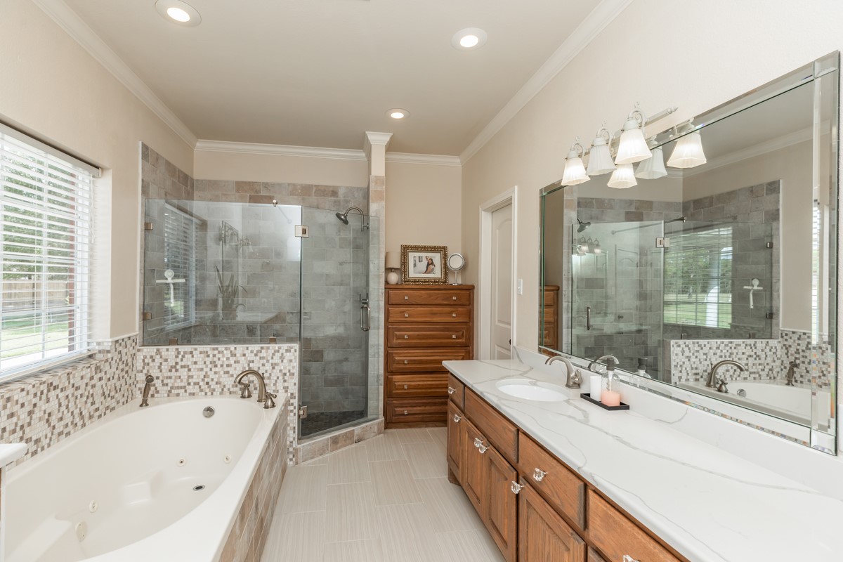430 Bonura Road Sour Lake, TX 77659 - Photo 27 of 50 a bathroom with a tub sink shower and mirror