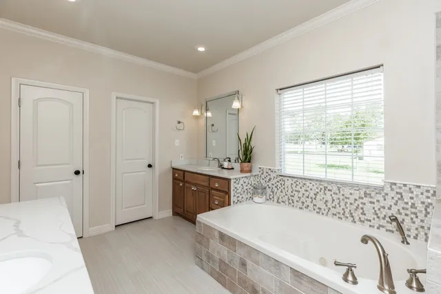 a bathroom with a bathtub and a sink