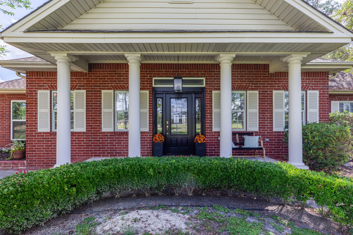 430 Bonura Road Sour Lake, TX 77659 - Photo 3 of 50 a front view of a building with a garden and plants