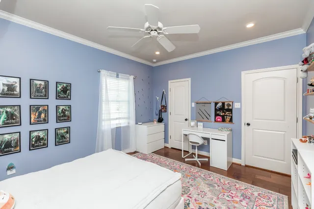 a bedroom with a bed cabinets and a window