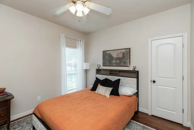 a bedroom with a bed and wooden floor