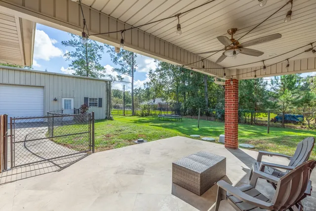 a view of a porch with furniture and a yard
