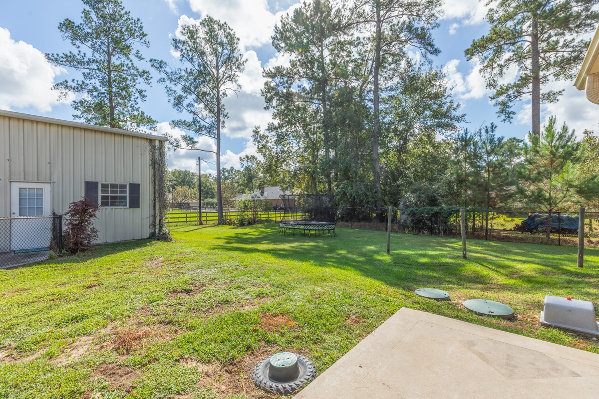 430 Bonura Road Sour Lake, TX 77659 - Photo 39 of 50 a view of a backyard with a garden and trees