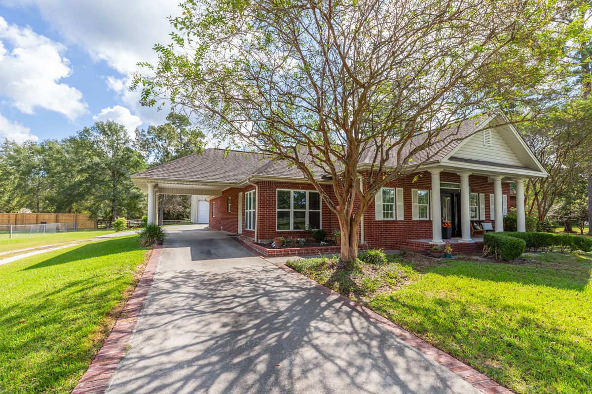 430 Bonura Road Sour Lake, TX 77659 - Photo 4 of 50 a front view of a house with garden