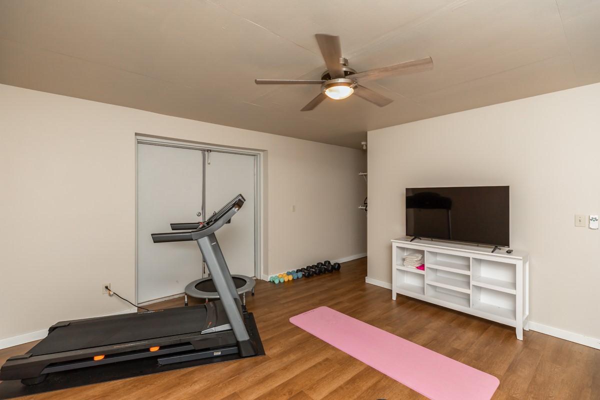 430 Bonura Road Sour Lake, TX 77659 - Photo 50 of 50 a living room with gym equipment and a flat screen tv
