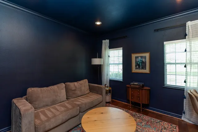 a living room with furniture a air conditioner vent and a window