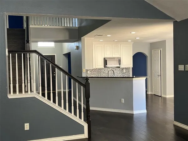 a view of a hallway with stainless steel appliances granite countertop furniture