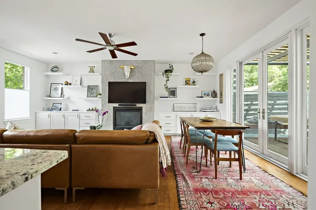 a kitchen with stainless steel appliances granite countertop a sink a stove and a refrigerator