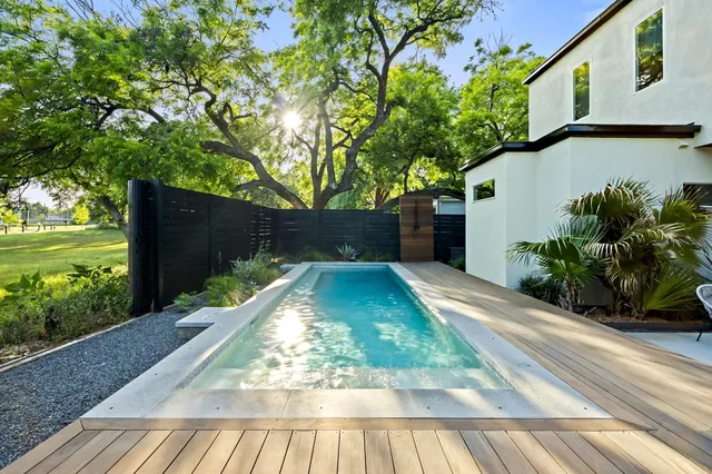 a view of a chair and table in backyard of the house