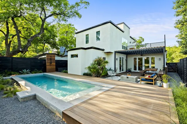 a view of a house with sitting area and garden