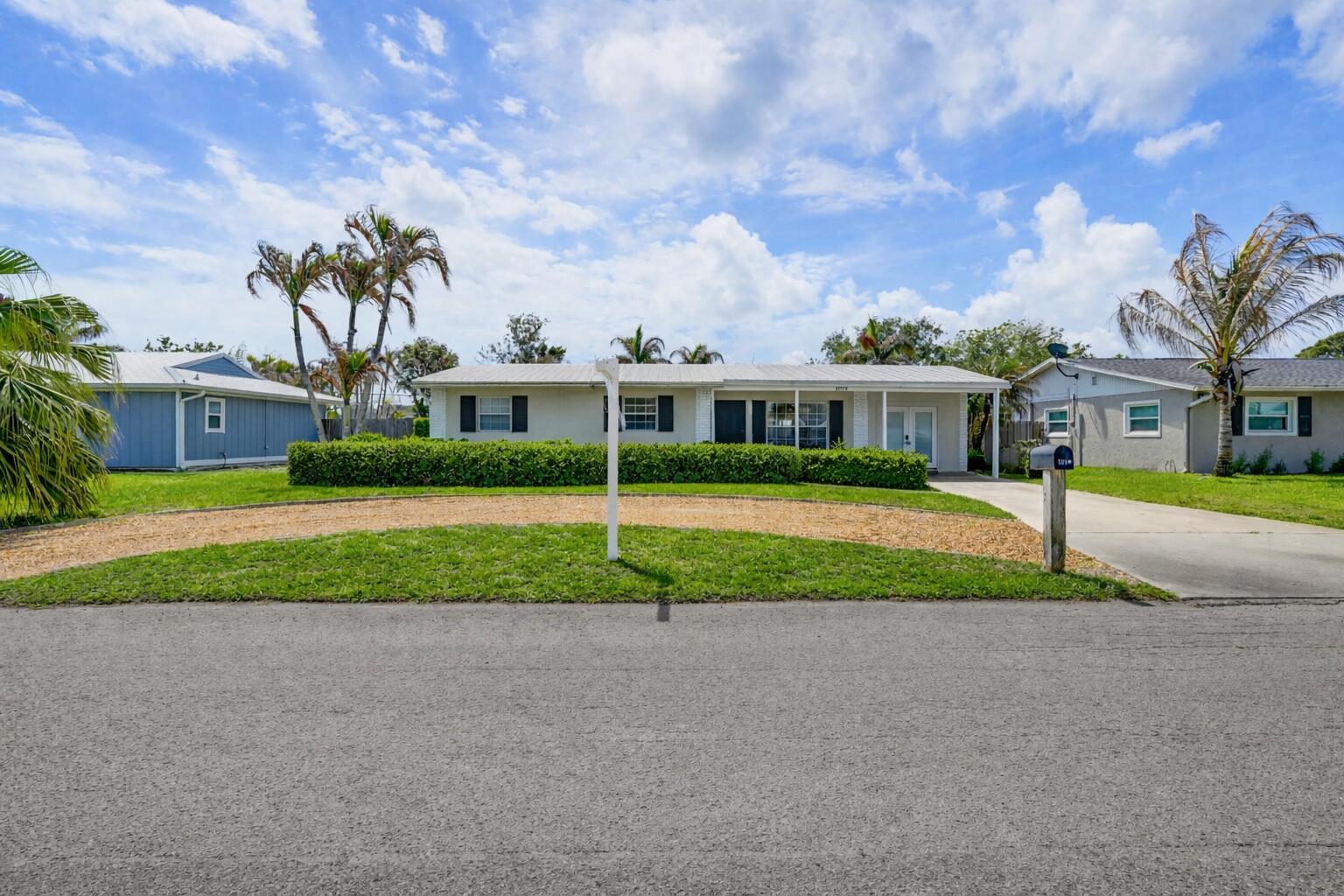 1864 Southeast Lafayette Street Stuart, FL 34997 - Photo 2 of 37 Suburban home with palm trees