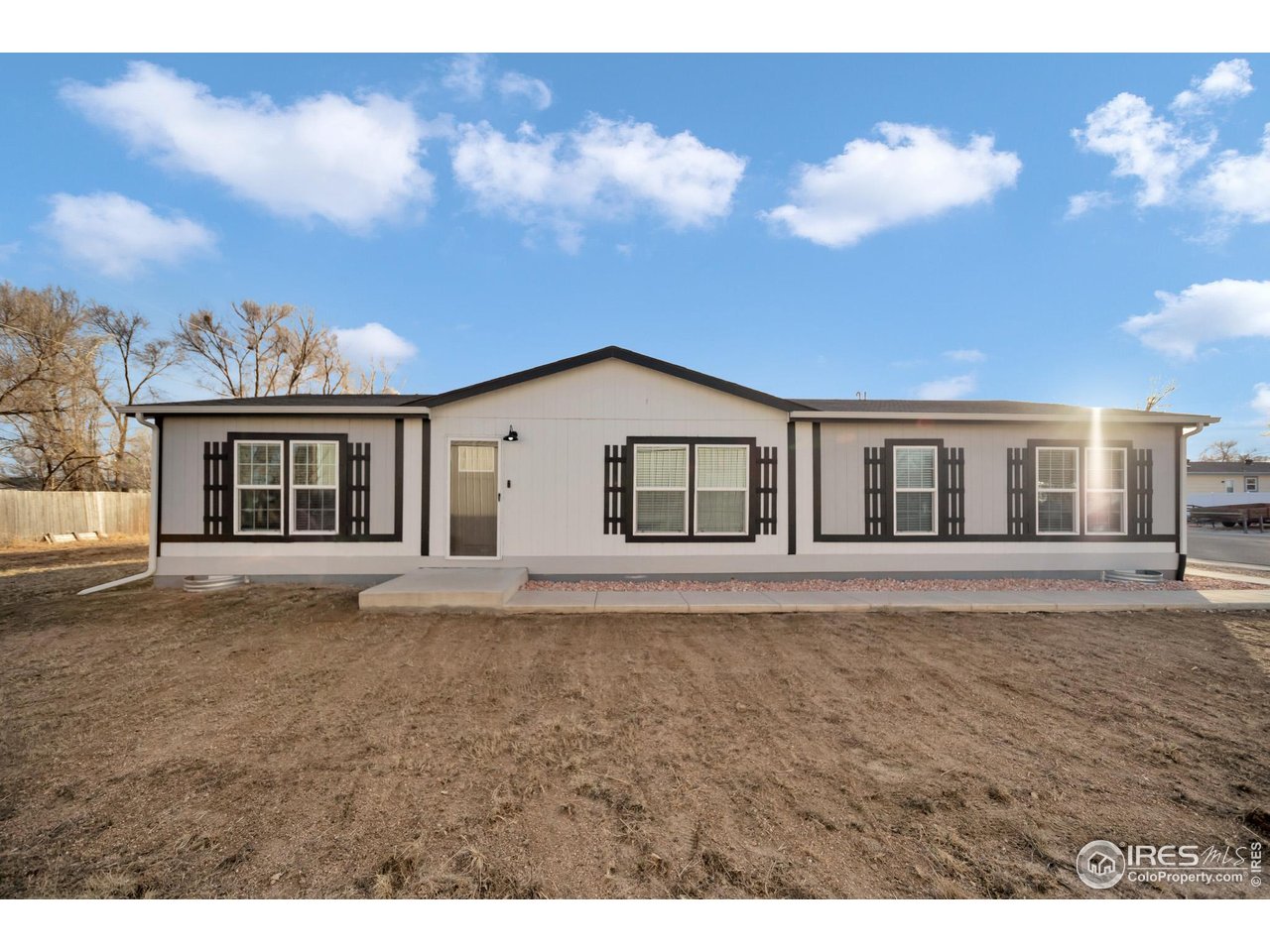 116 Ash Street Log Lane Village, CO 80705 - Photo 1 of 21 a view of a house with a backyard