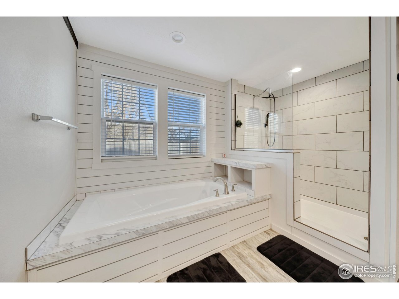 116 Ash Street Log Lane Village, CO 80705 - Photo 13 of 21 a bathroom with a bathtub and a shower