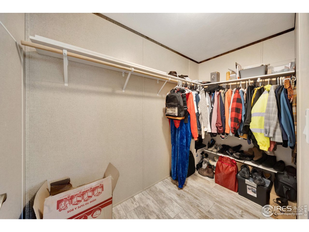 116 Ash Street Log Lane Village, CO 80705 - Photo 17 of 21 a view of walk in closet with clothes and shoes