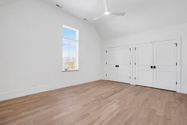 a bathroom with a toilet sink vanity and mirror