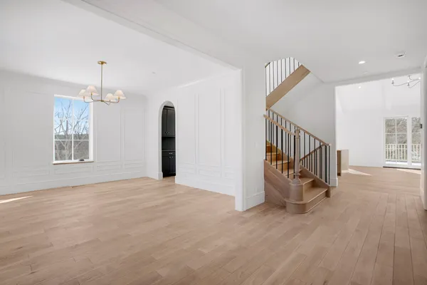 an empty room with stairs and windows