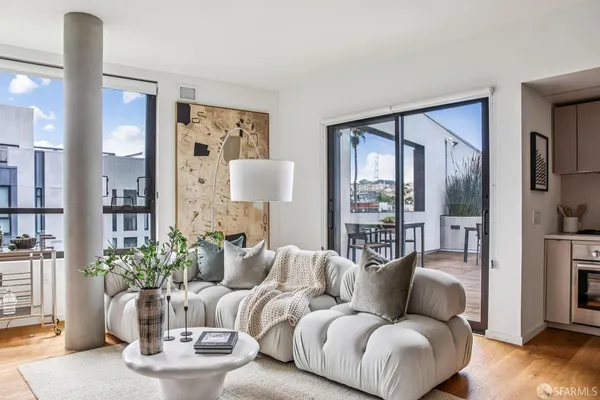 a living room with furniture and a potted plant