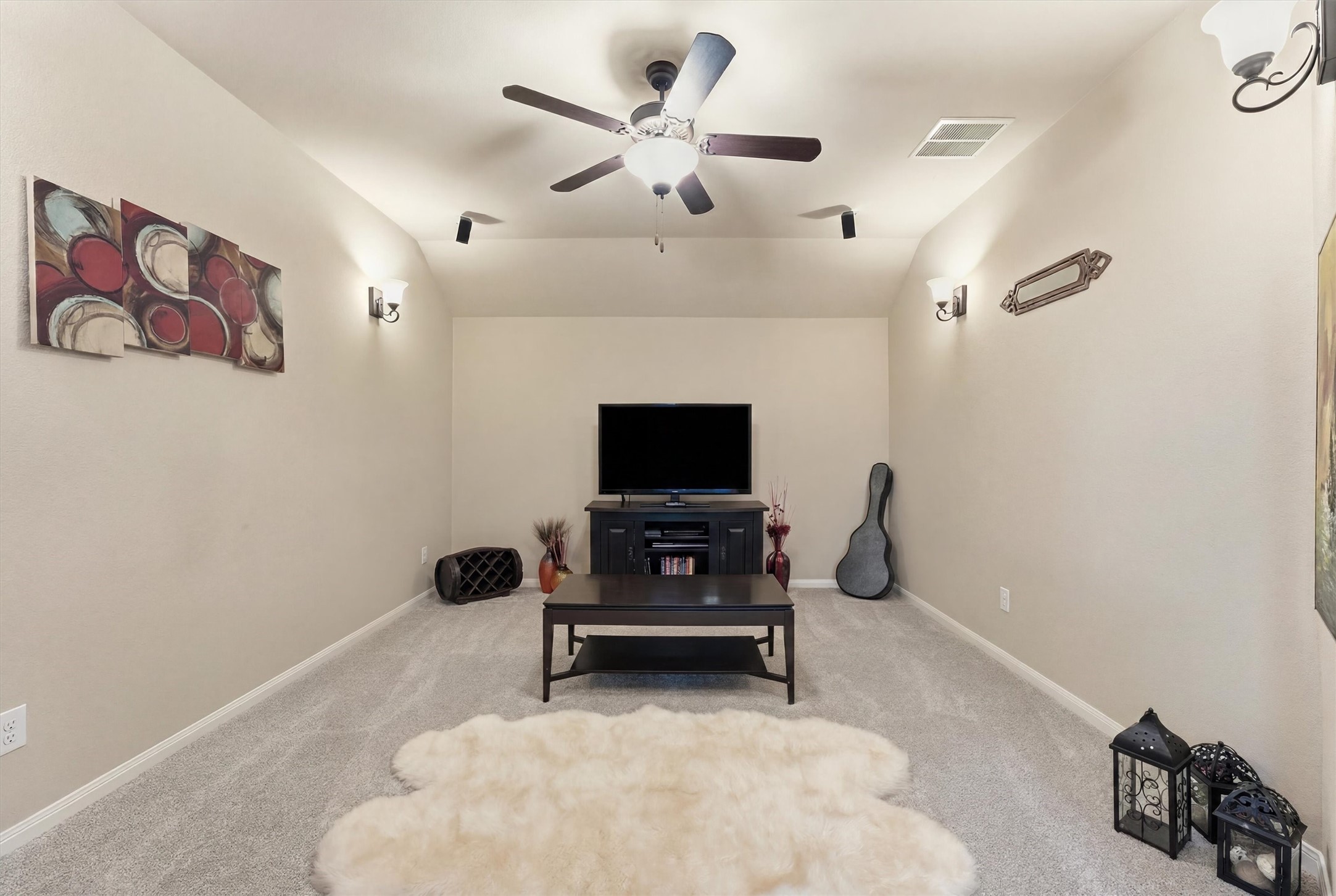 17710 Rough River Court Humble, TX 77346 - Photo 24 of 38 This cozy media room features soft carpeting, a ceiling fan, and ambient wall lighting.