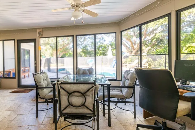 a dining room with furniture water view and large windows