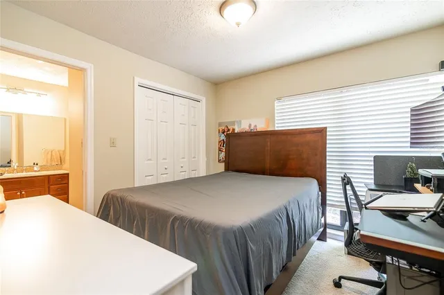 a bedroom with a bed a table and chair