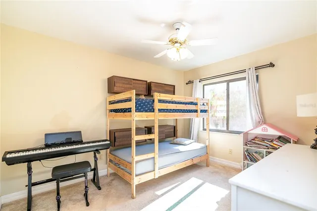 a bedroom with furniture and a large window