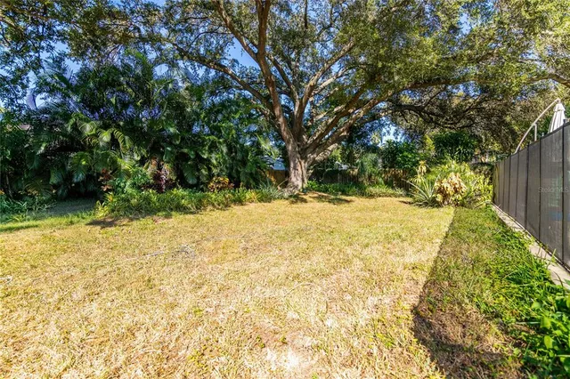 a view of white house with a yard