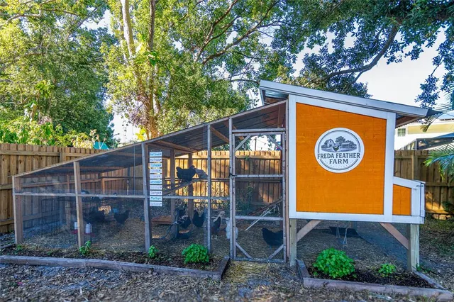a view of a house with a backyard and wooden fence