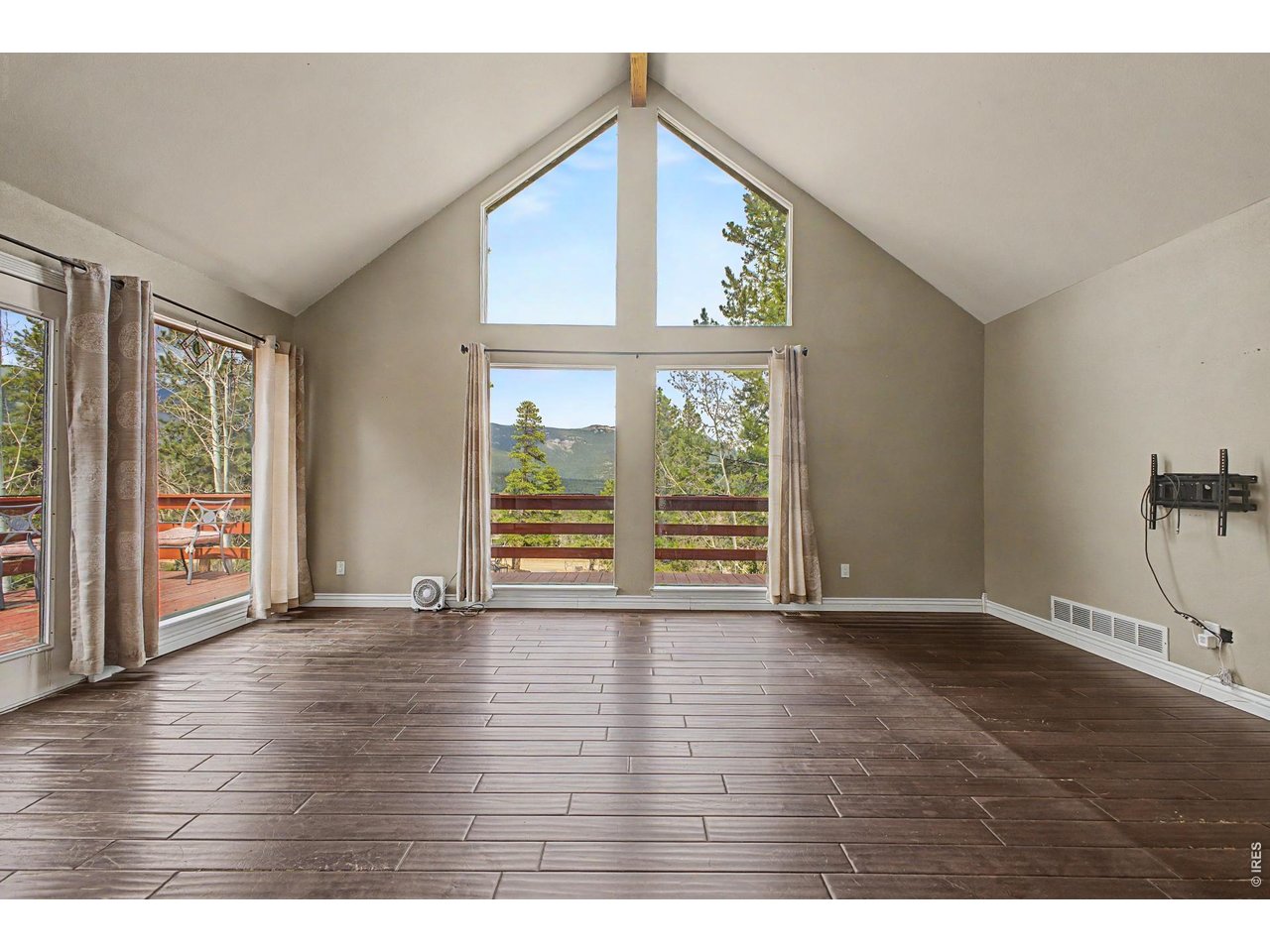 76 Highlands Drive Bailey, CO 80421 - Photo 6 of 49 a view of an empty room with wooden floor and a window