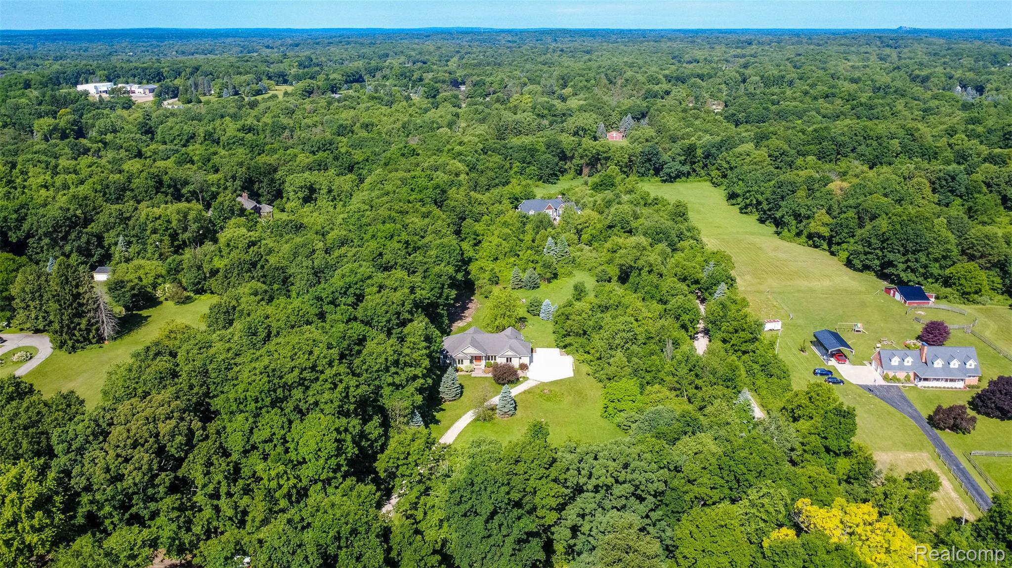 9887 Hadley Road Clarkston, MI 48348 - Photo 45 of 56 Aerial perspective showcasing a sprawling property set amidst extensive mature tree coverage