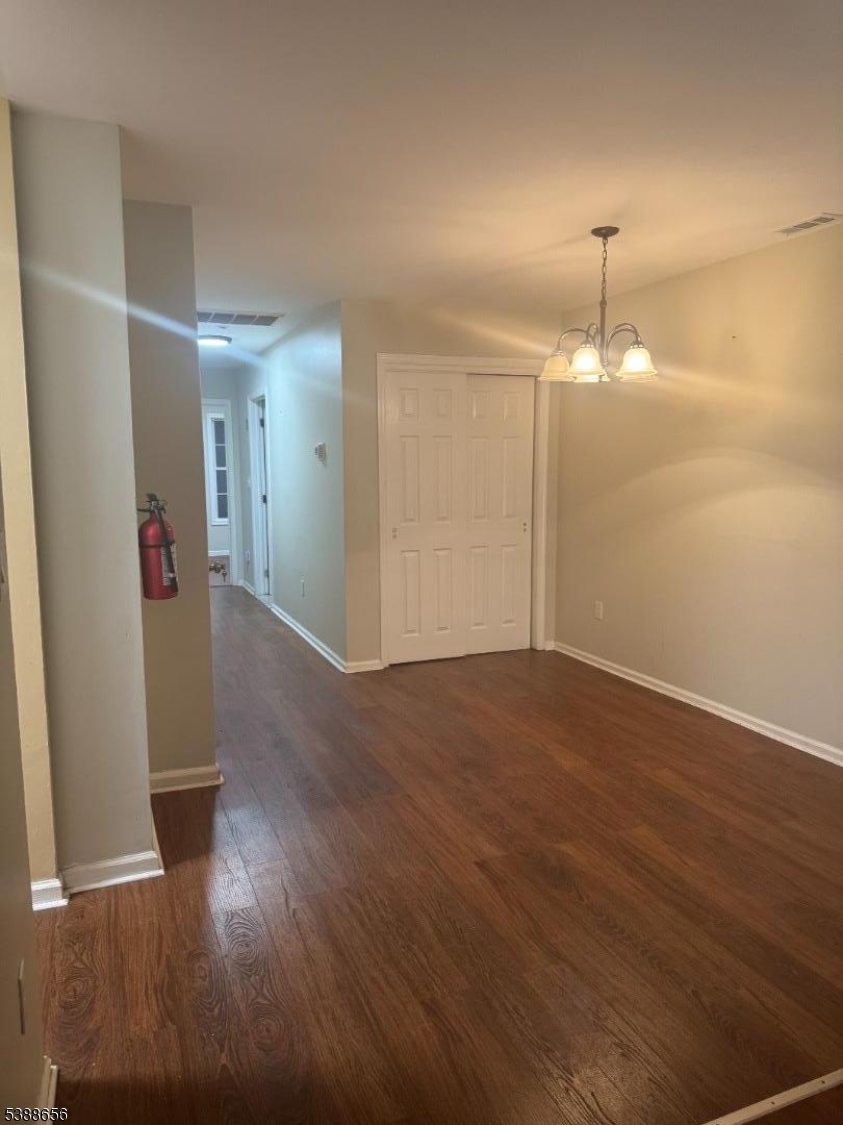 406 South 7th Street, Unit 2 Newark, NJ 07103 - Photo 12 of 13 an empty room with wooden floor and windows