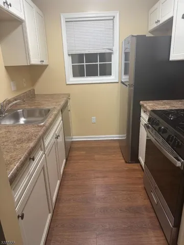a kitchen with a stove and a refrigerator