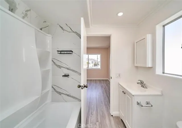 a bathroom with a bathtub and a sink