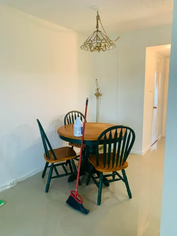 a view of a dining room with furniture and a chandelier fan