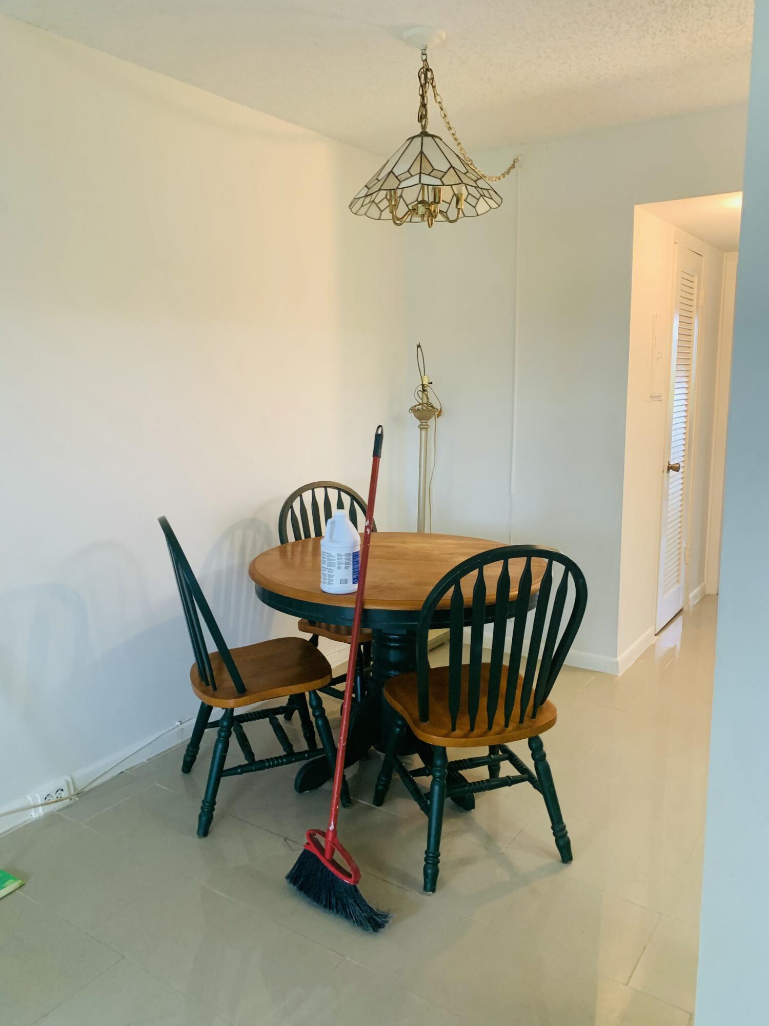 7 Suffolk A Boca Raton, FL 33434 - Photo 13 of 19 a view of a dining room with furniture and a chandelier fan