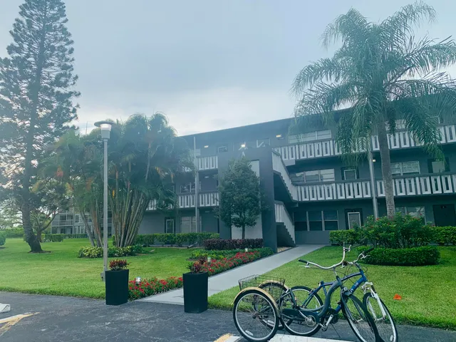 a view of a chair and table in backyard of the house