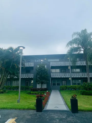 a front view of a building with garden