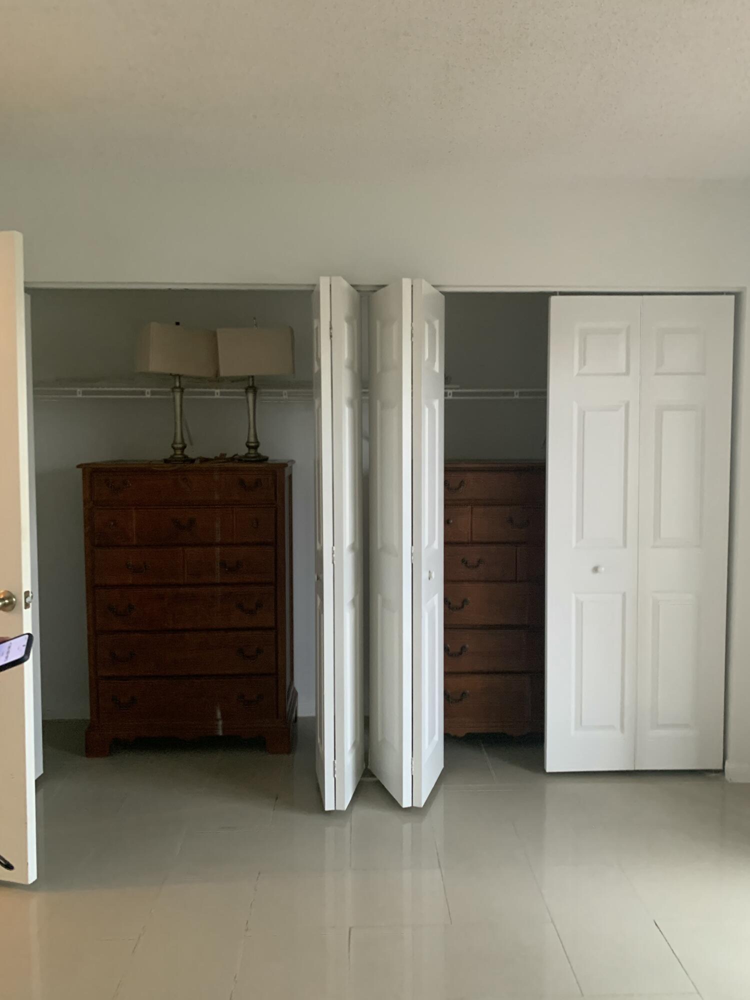 7 Suffolk A Boca Raton, FL 33434 - Photo 6 of 19 an empty room with closet and mirrors