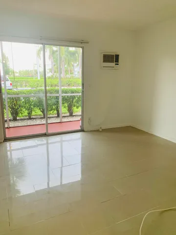 a view of an empty room and a window